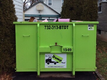 A 15 yard dumpster with debris in it